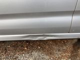a close up of a car ' s side door with a hole in the side