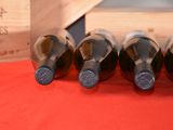 bottles of wine are lined up in a row on a table