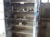 a metal cabinet that has a bunch of items inside of it