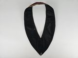 a close up of a black leather collar on a white background