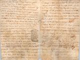 an old manuscript with writing on it sitting on top of a table