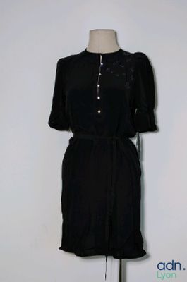 a picture of a black dress on a mannequin stand