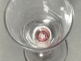 a wine glass with a red liquid inside of it