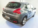a grey car that is parked in a white room