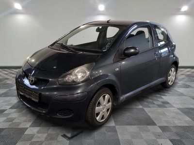 a picture of a small black car parked in a garage