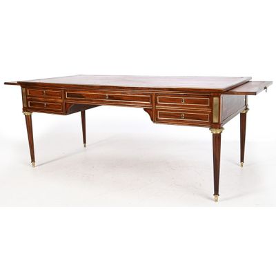 an antique writing desk with two drawers and a brass plated top