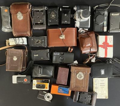 a lot of old cameras and other items on the table