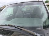 a car that is parked in a lot with a windshield wiper