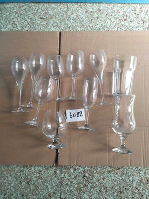 many empty wine glasses sitting on a cardboard box