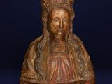 a wooden bust of a woman with a crown on her head