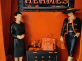 two mannequins that are standing in a display case