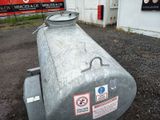 a large metal tank sitting outside of a building