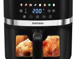 an image of a black air fryer with a chicken inside