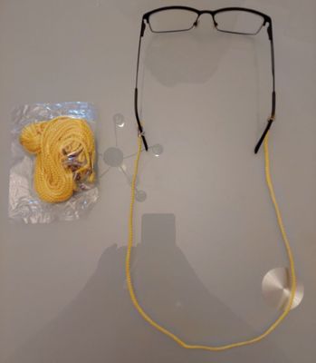 a pair of glasses and a ball of yarn next to a pair of glasses