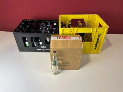 a bottle of alcohol and a box of beer on a table