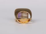 an image of a gold ring with a purple stone in it