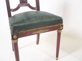a chair with a green upholstered seat on a white background
