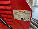 an image of a close up of a red machine on a table
