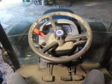 a steering wheel of a tractor in a garage
