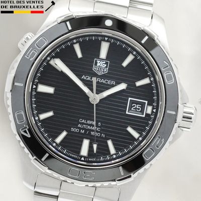 a close up of a watch on a white surface