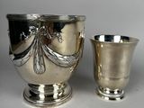 silver plated cup and a silver plated cup on a white surface