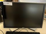 the computer monitor is sitting on the desk next to the keyboard
