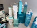 many different types of skin care products displayed on a table