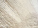 a close up of a white and black blanket on a bed