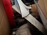 a person holding a pair of scissors in a box