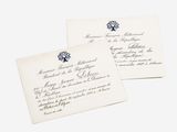 two envelopes with blue and white designs on them sitting next to each other