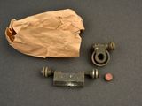 a brown paper bag and a couple of metal fittings on a table