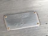 an old silver suitcase with a metal plaque on the side of it