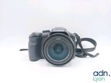 a camera that is sitting on a white surface
