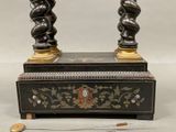 a black and gold table with a clock on it