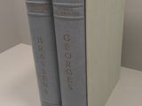 two books are stacked on top of each other on a table