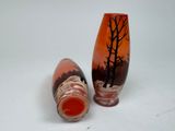 two vases sitting next to each other on a white surface