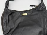 a black leather shoulder bag with gold hardware