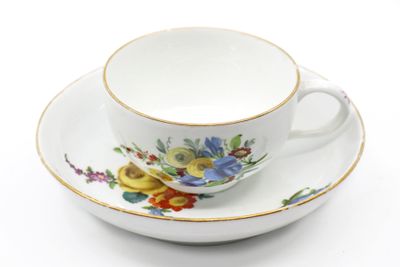 a cup and saucer with a floral design on it