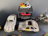 several toy cars and motorcycles are lined up on a table