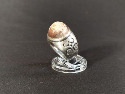 a close up of a silver object on a black surface