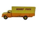un camion miniature sur lequel est accrochée une pancarte sur le côté