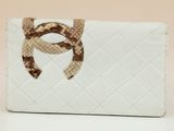 wallet with a snake embellishment on the front of the wallet