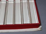 a red box that has a bunch of silver spoons in it