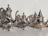 many silver objects on a white surface