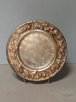 a silver plate on a stand on a table