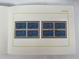 an open book with a picture of blue stamps on it