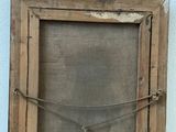 an old wooden frame with a rope hanging from it