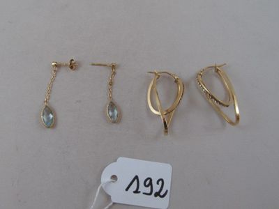 three pairs of earrings and a tag on a white surface