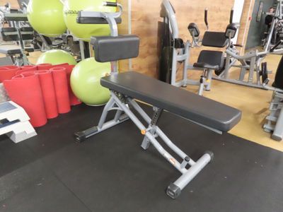 an image of a gym room with a bench and exercise balls
