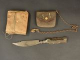 a knife, wallet, and chain on a table